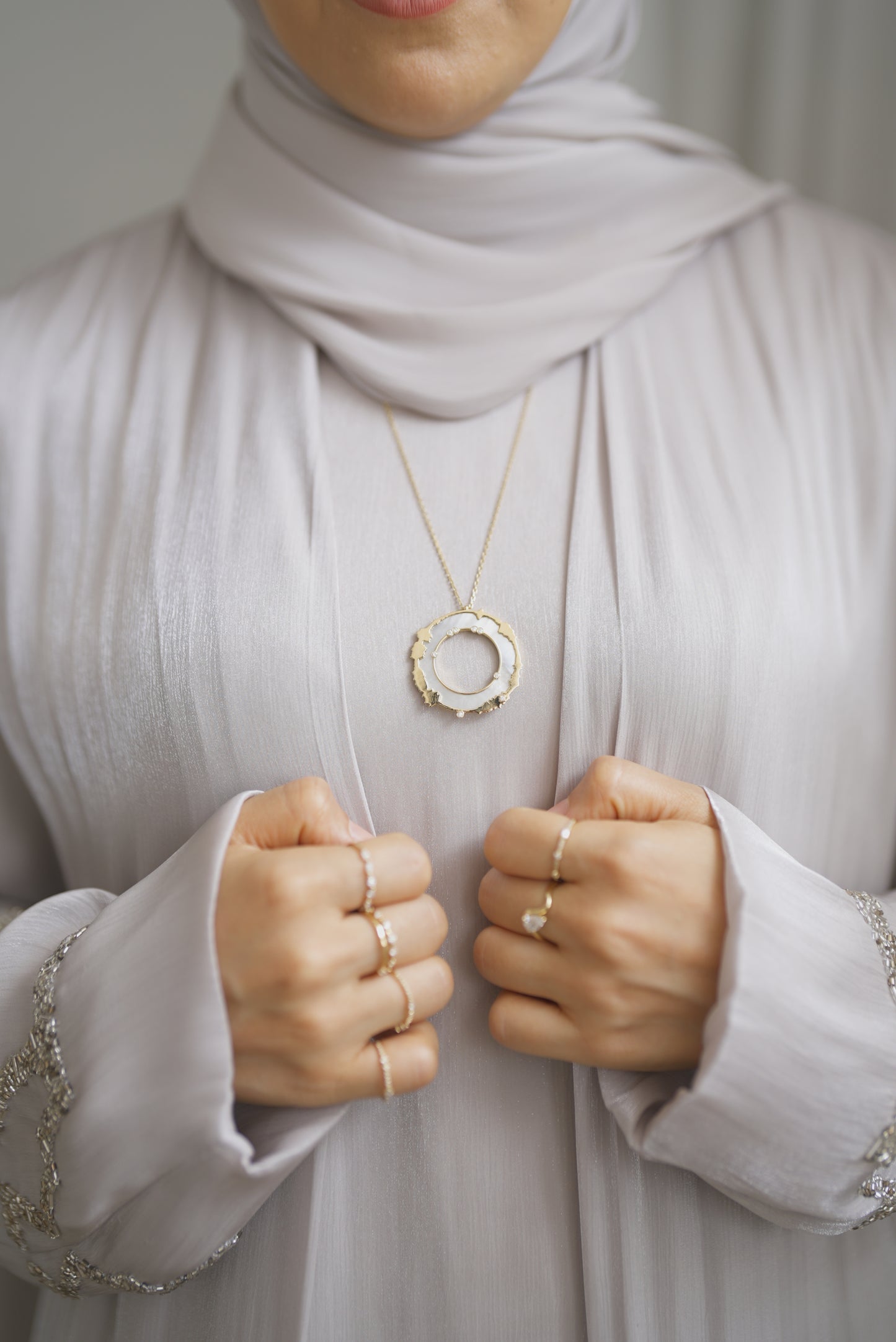 18k gold and diamond soundwaves of quraan. mother of pearl stone.