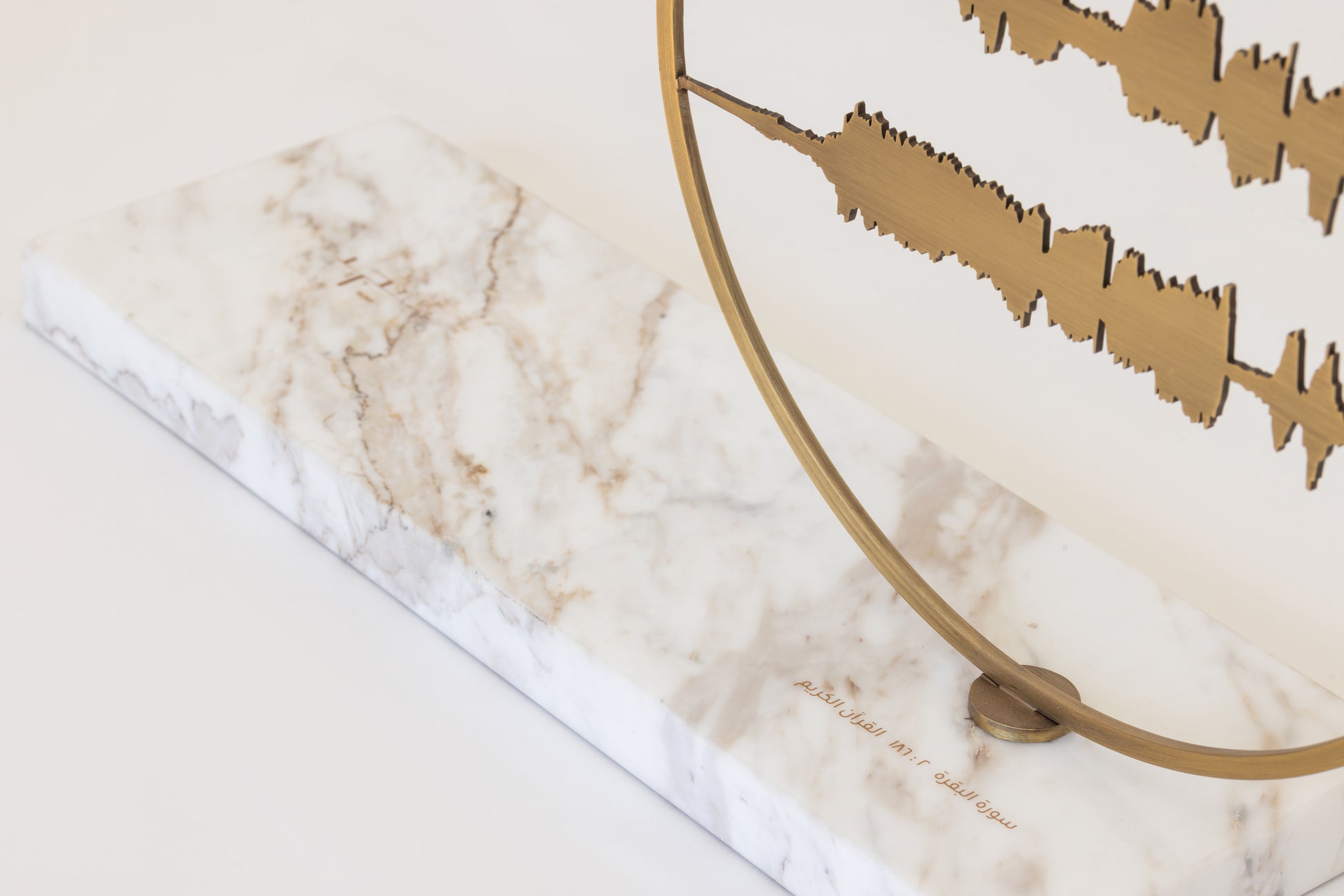 quraan sound waves artwork in brass on marble
