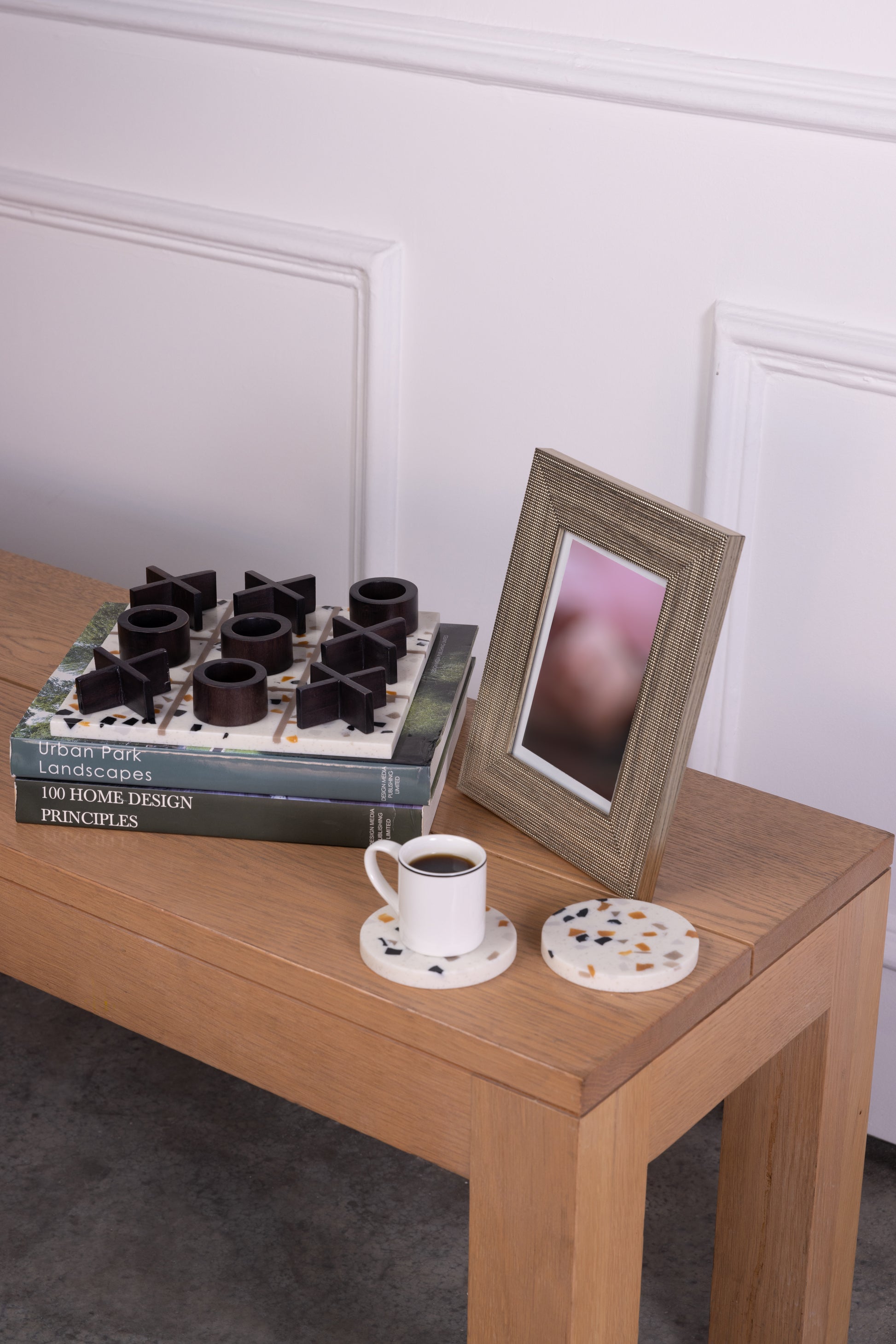 x and o board game and coasters for your coffee