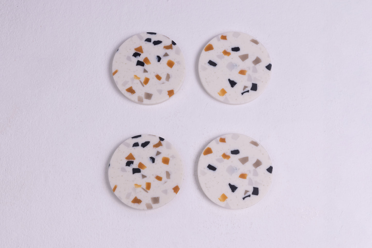 four terrazzo coasters to serve your guests